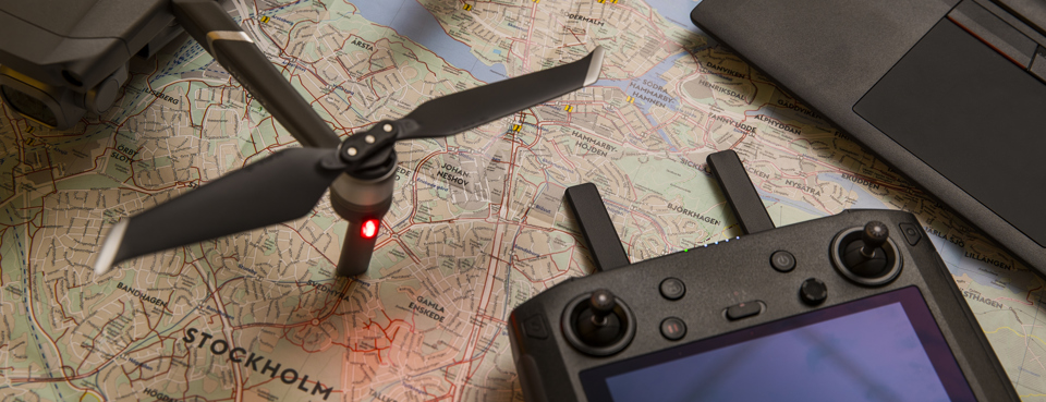 Digitala verktyg, drönare och dator, ligger på en karta.